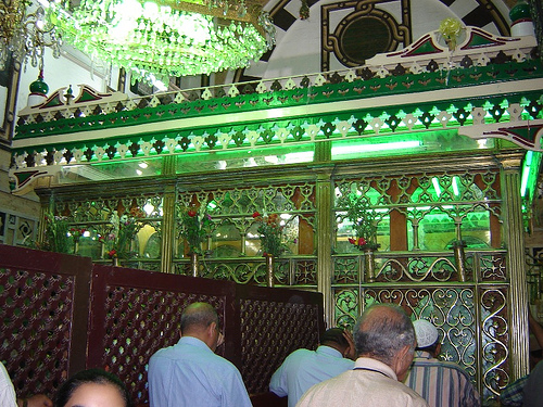 Shrine-goers walk along a path to the enclosure around Nafisah’s tomb.